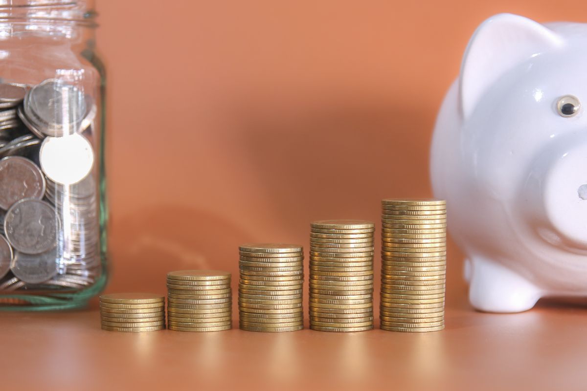 A concept of showing the growing savings account using coins and piggy bank 