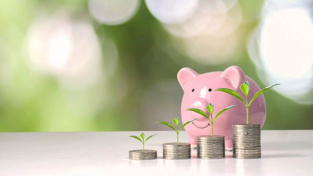 The growing trees on the money stacks include a pink pig piggy b